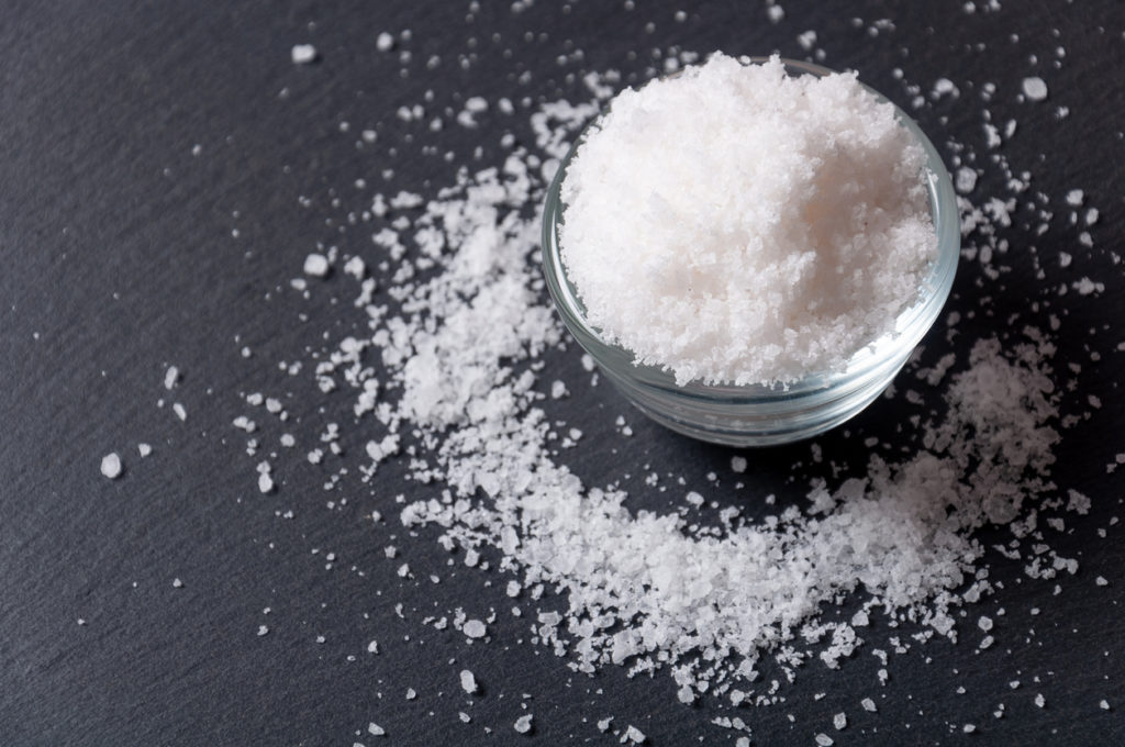 Salt on a black surface table.